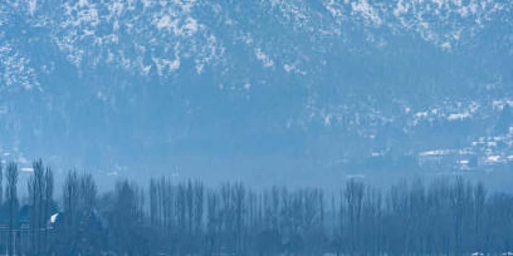 A view of Dal Lake in winter, and the beautiful snowcapped mountain range in the background in the city of Srinagar, Kashmir, India.